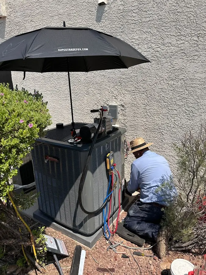 HVAC technician performing outdoor AC maintenance in Bowie